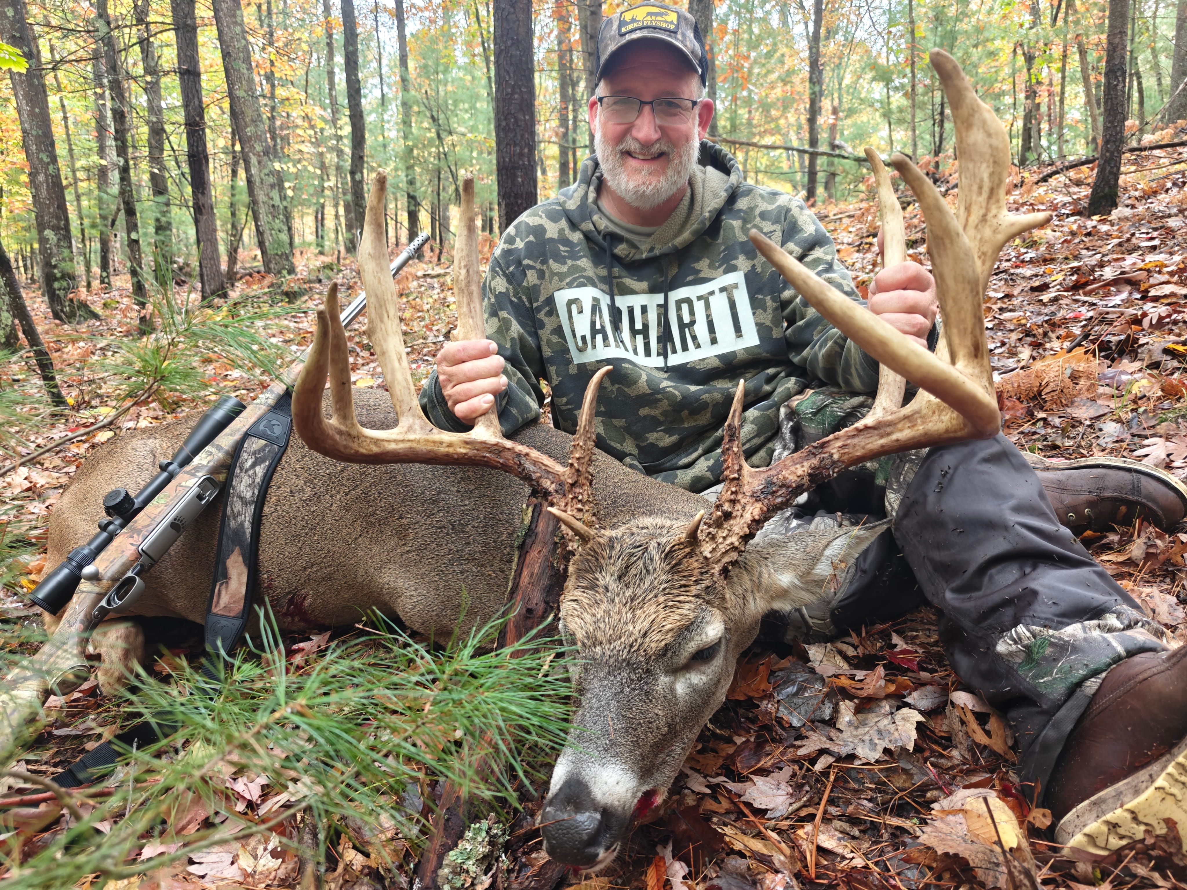 Hunter with a heavy trophy whitetail buck in Branch, Michigan